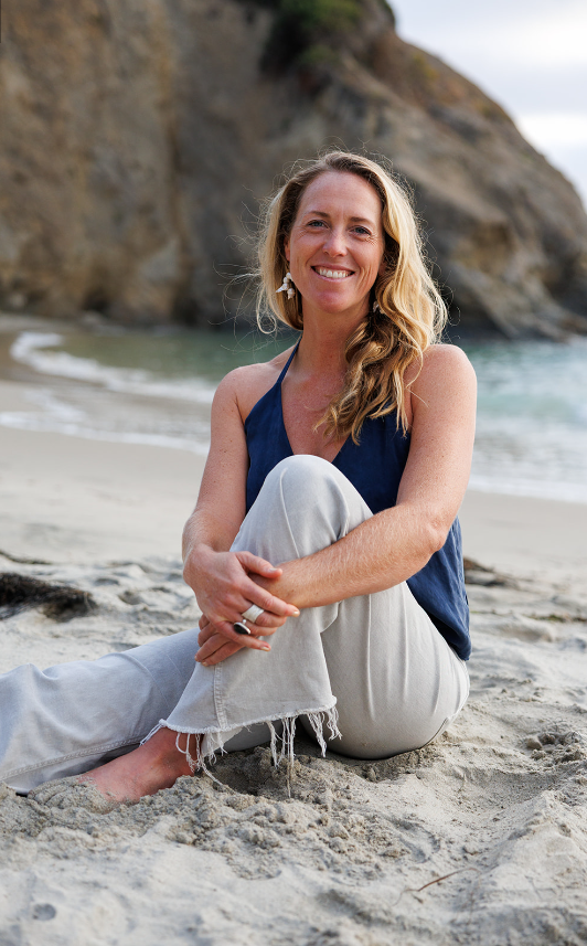 sitting on beach, blue shirt Kendall Perrine